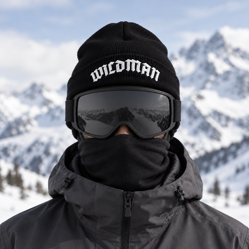 WILDMAN beanie worn with plain black ski goggles and face-covering buff in snowy mountains